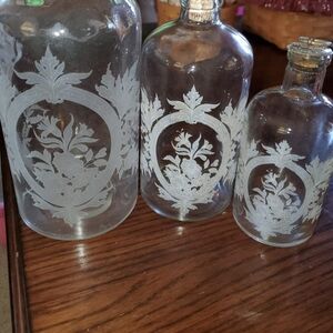 Set of Three Vintage Glass Bottles with Floral Design